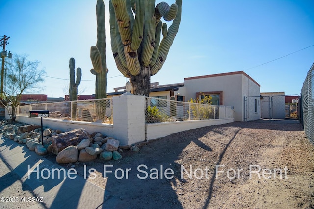 exterior space featuring stucco siding, fence private yard, and a gate