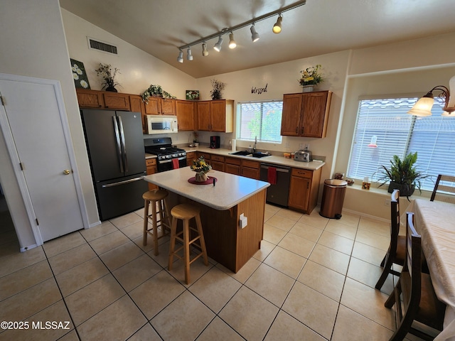 60464 E Blackcrest Loop, Tucson, AZ 85739 - kitchen featuring a sink, freestanding refrigerator, white microwave, stainless steel range with gas cooktop, and dishwashing machine