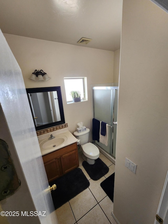60464 E Blackcrest Loop, Tucson, AZ 85739 - bathroom with visible vents, tile patterned flooring, a shower stall, vanity, and toilet