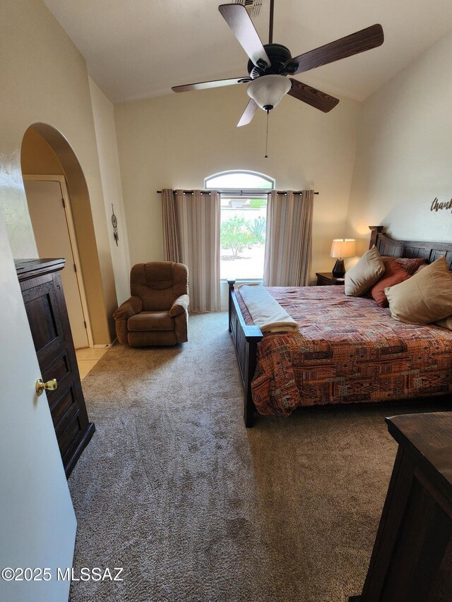 60464 E Blackcrest Loop, Tucson, AZ 85739 - carpeted bedroom featuring vaulted ceiling, arched walkways, and a ceiling fan