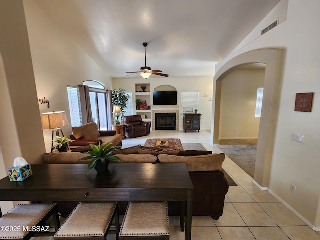 60464 E Blackcrest Loop, Tucson, AZ 85739 - living area with baseboards, ceiling fan, built in shelves, arched walkways, and light tile patterned floors