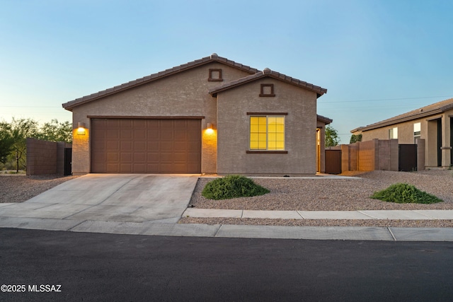 3352 W Shadow Park Way, Tucson, AZ 85742 - view of front of home featuring a garage, driveway, and stucco siding