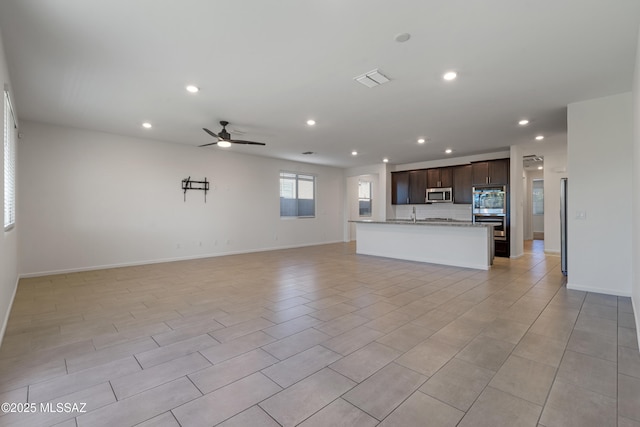 3352 W Shadow Park Way, Tucson, AZ 85742 - unfurnished living room with a ceiling fan, recessed lighting, baseboards, and a sink