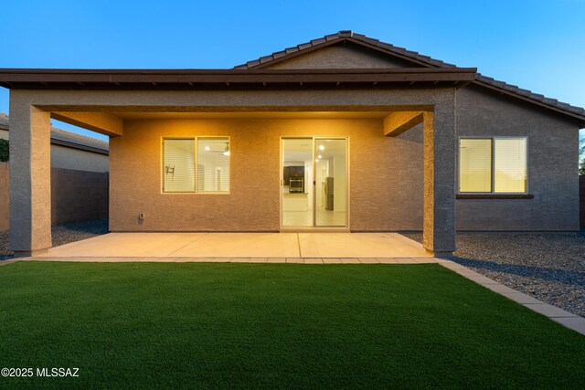 3352 W Shadow Park Way, Tucson, AZ 85742 - back of house at dusk featuring stucco siding and a patio