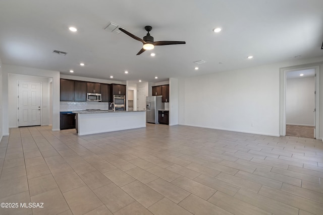 3352 W Shadow Park Way, Tucson, AZ 85742 - unfurnished living room with a ceiling fan, recessed lighting, baseboards, and a sink