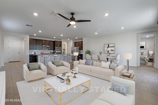 3352 W Shadow Park Way, Tucson, AZ 85742 - living area featuring ceiling fan, recessed lighting, and baseboards