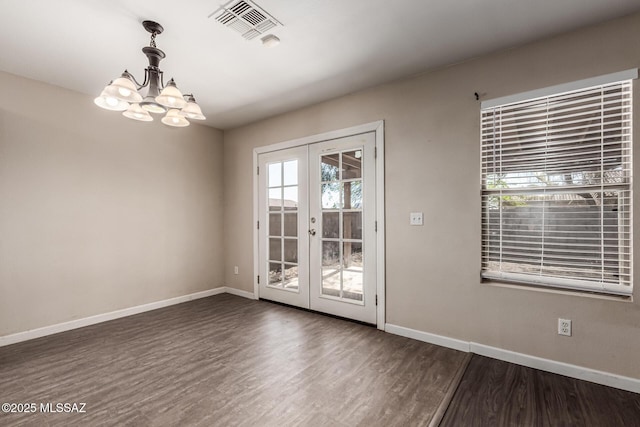 interior space with a notable chandelier, visible vents, dark wood-style flooring, and french doors