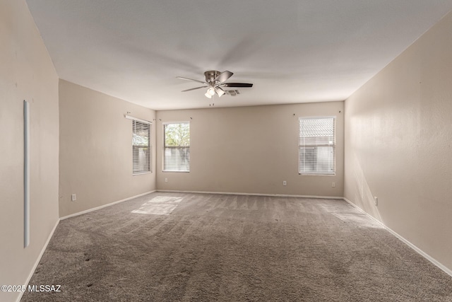 empty room with baseboards, carpet floors, and ceiling fan