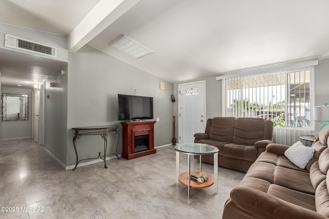 living room with baseboards, vaulted ceiling with beams, visible vents, and a fireplace