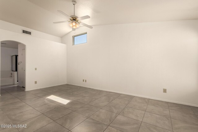 spare room with high vaulted ceiling, a ceiling fan, tile patterned floors, arched walkways, and visible vents