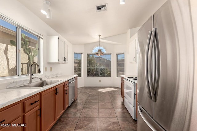 kitchen with visible vents, a wealth of natural light, stainless steel appliances, and a sink