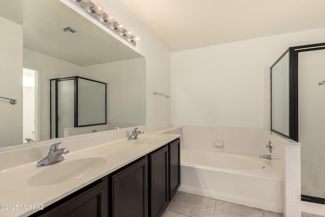 bathroom featuring visible vents, tile patterned floors, a garden tub, and a sink