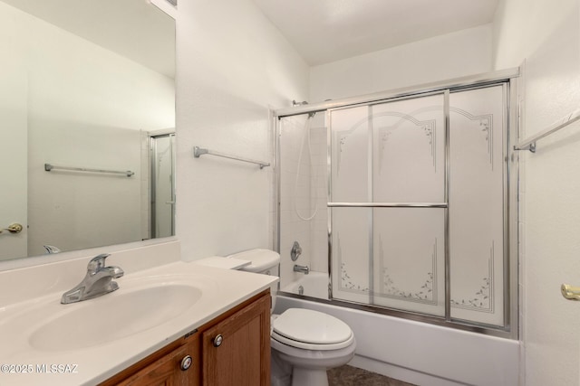 full bathroom featuring bath / shower combo with glass door, toilet, and vanity