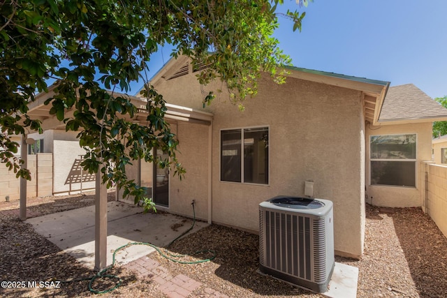 rear view of house featuring fence, a patio, cooling unit, and stucco siding