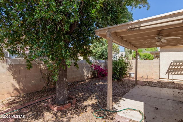 view of yard featuring a fenced backyard, a ceiling fan, and a patio