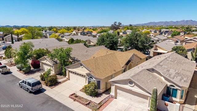 birds eye view of property with a mountain view and a residential view