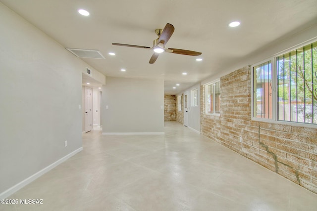 5754 S Ray Stra, Tucson, AZ 85706 - spare room with brick wall, recessed lighting, a ceiling fan, and baseboards