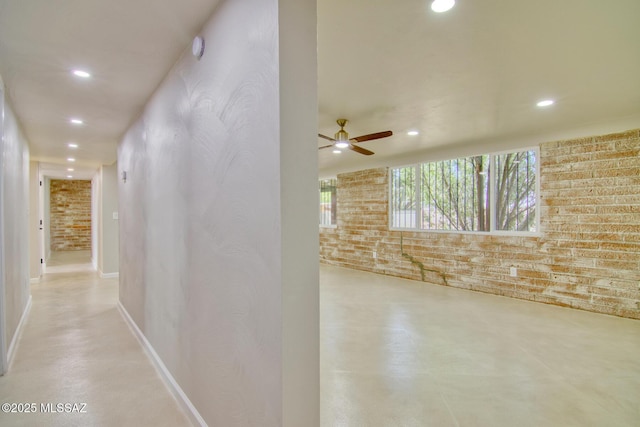5754 S Ray Stra, Tucson, AZ 85706 - corridor with recessed lighting, baseboards, concrete floors, and brick wall
