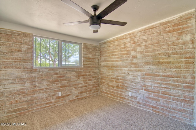 5754 S Ray Stra, Tucson, AZ 85706 - unfurnished room with a ceiling fan, carpet flooring, and brick wall