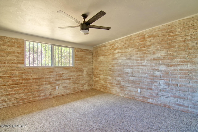 5754 S Ray Stra, Tucson, AZ 85706 - carpeted spare room featuring a ceiling fan and brick wall