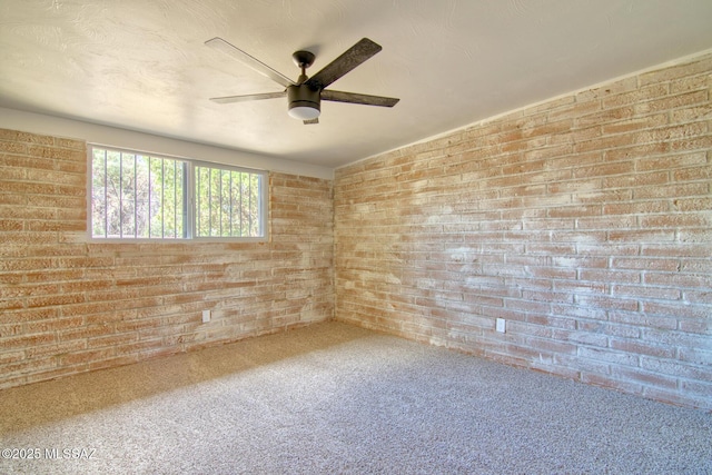 5754 S Ray Stra, Tucson, AZ 85706 - spare room featuring brick wall, a ceiling fan, and carpet floors