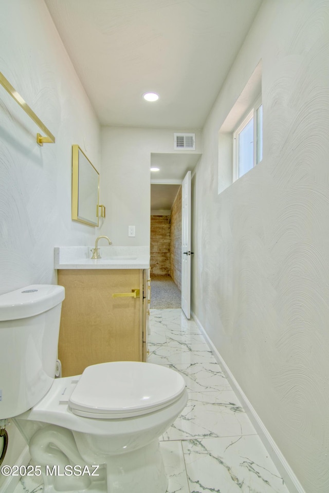 5754 S Ray Stra, Tucson, AZ 85706 - half bath with marble finish floor, toilet, vanity, baseboards, and visible vents