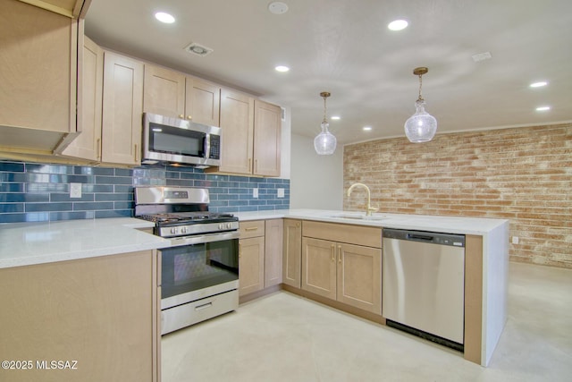 5754 S Ray Stra, Tucson, AZ 85706 - kitchen with light brown cabinetry, a sink, a peninsula, and stainless steel appliances
