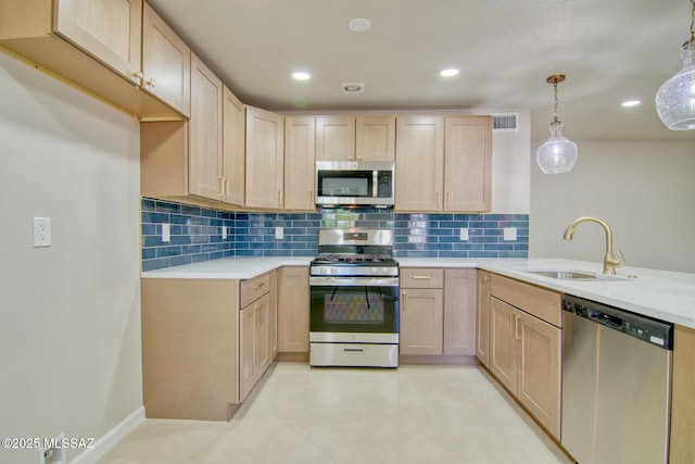 5754 S Ray Stra, Tucson, AZ 85706 - kitchen featuring appliances with stainless steel finishes, decorative backsplash, light brown cabinetry, and a sink