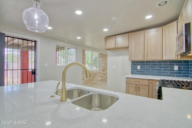 5754 S Ray Stra, Tucson, AZ 85706 - kitchen with stainless steel appliances, a healthy amount of sunlight, light stone counters, and a sink