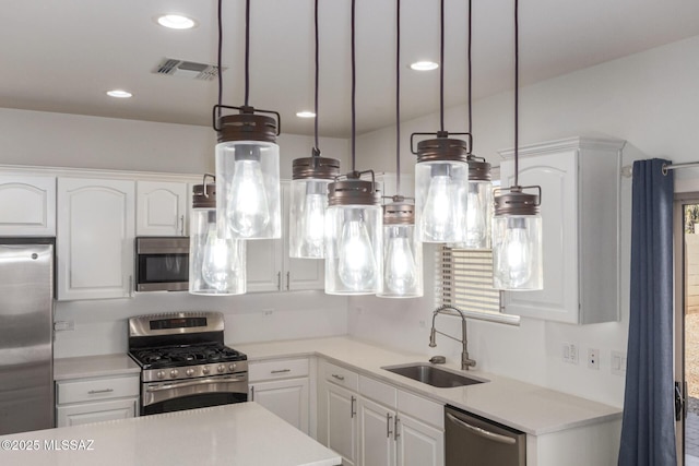 kitchen featuring white cabinets, visible vents, a sink, and appliances with stainless steel finishes