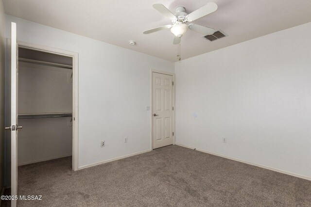 unfurnished bedroom with a closet, ceiling fan, baseboards, carpet flooring, and visible vents