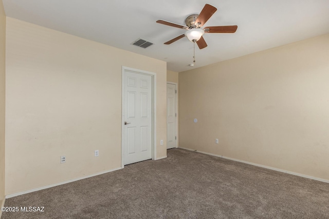 unfurnished bedroom with carpet floors, a ceiling fan, visible vents, and baseboards