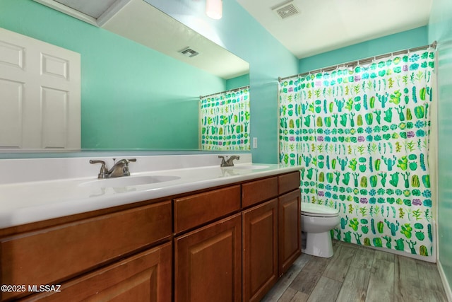 full bath featuring wood finished floors, visible vents, and a sink