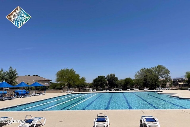 pool featuring fence and a patio area