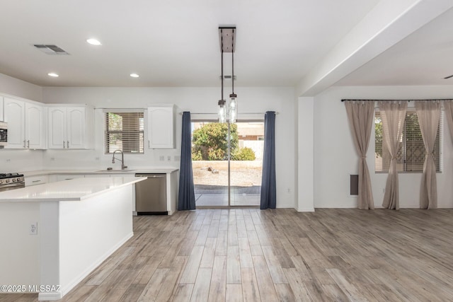 kitchen featuring light countertops, visible vents, appliances with stainless steel finishes, and a sink