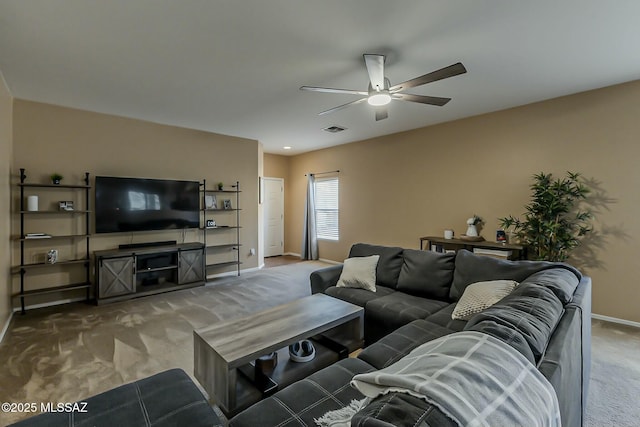 living area with carpet floors, visible vents, a ceiling fan, and baseboards
