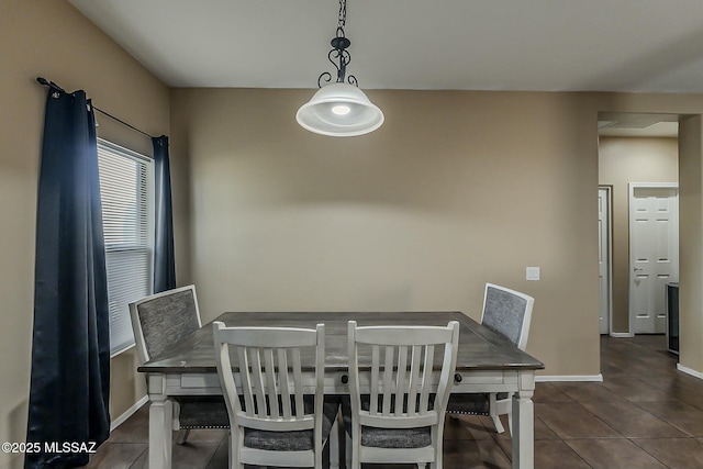 dining space with tile patterned floors and baseboards