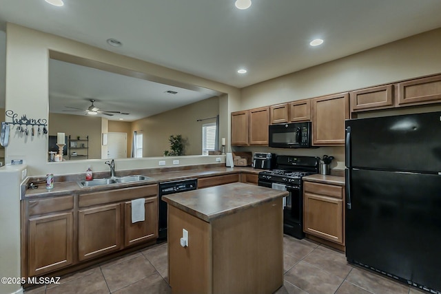 kitchen with a kitchen island, tile patterned flooring, a sink, and black appliances