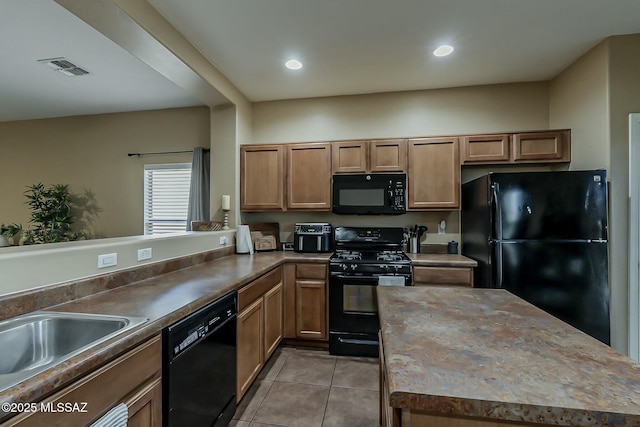 kitchen featuring recessed lighting, visible vents, light tile patterned floors, and black appliances
