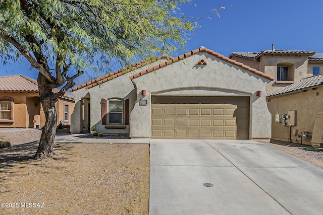 mediterranean / spanish home with stucco siding, a tile roof, driveway, and a garage