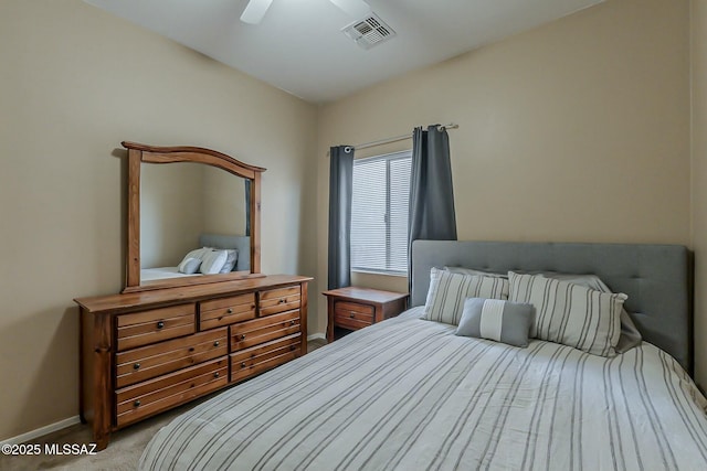 carpeted bedroom with ceiling fan, baseboards, and visible vents