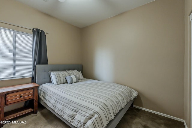 bedroom featuring baseboards and carpet