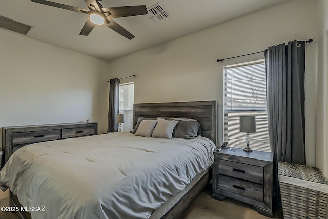 carpeted bedroom featuring visible vents and ceiling fan