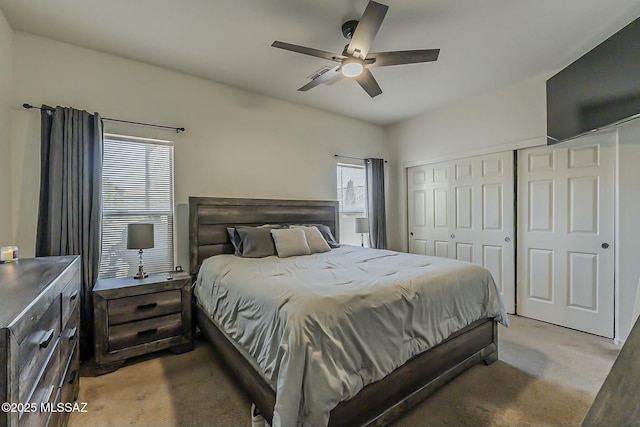 carpeted bedroom with a ceiling fan and a closet