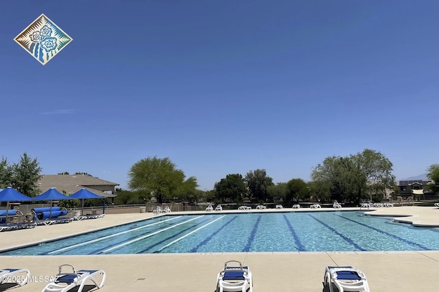 pool featuring fence and a patio area