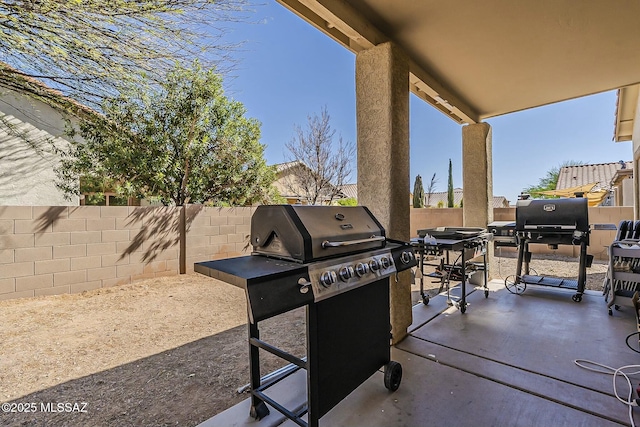view of patio with a fenced backyard and a grill