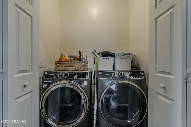 washroom featuring washer and clothes dryer and laundry area