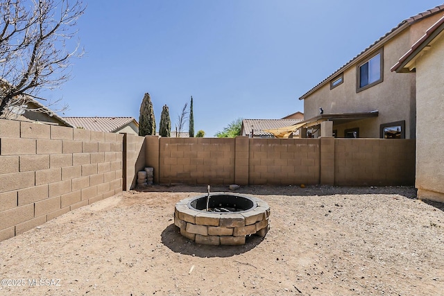view of yard featuring a fenced backyard and an outdoor fire pit