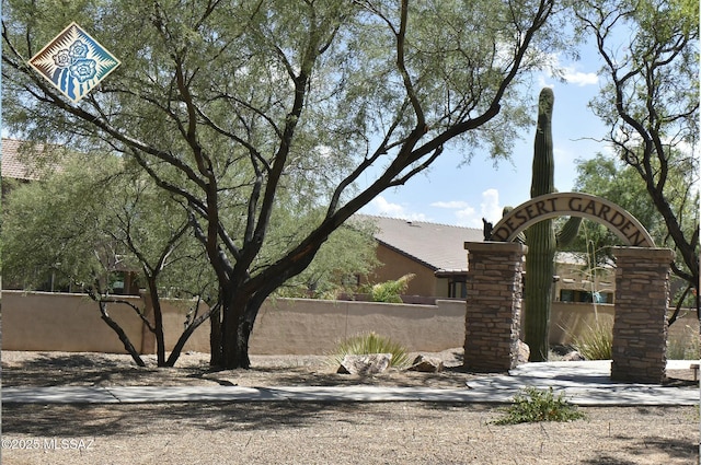 community sign featuring fence