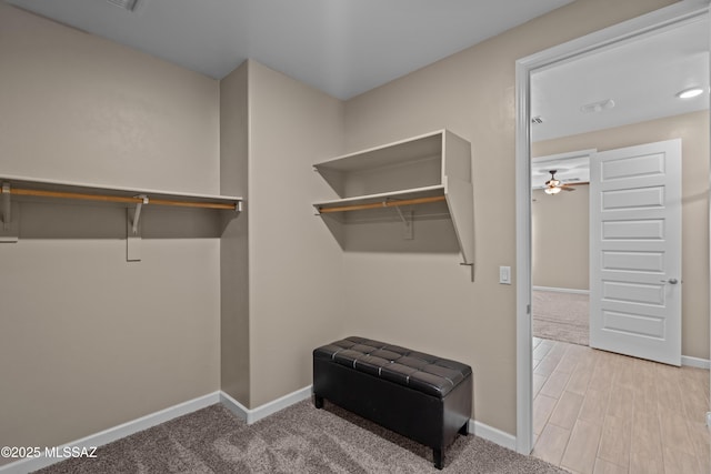 walk in closet featuring ceiling fan